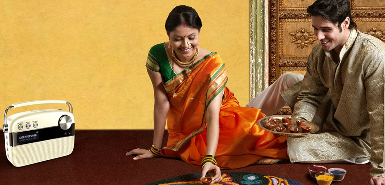 Husband and wife listening to Marathi carvaan music